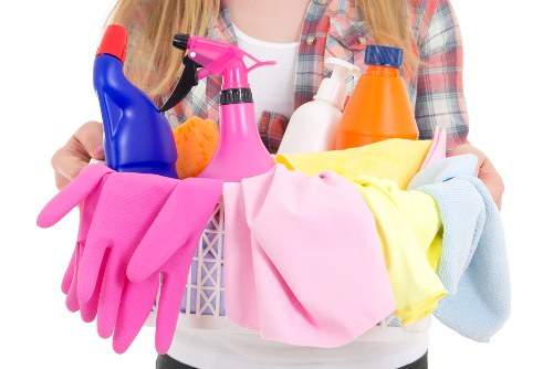 Domestic cleaner preparing a tidy SW3 living room for a regular home visit