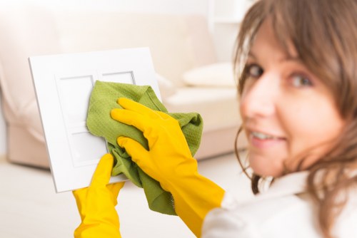 Operative managing carpet cleaning hose and trip hazards in a room